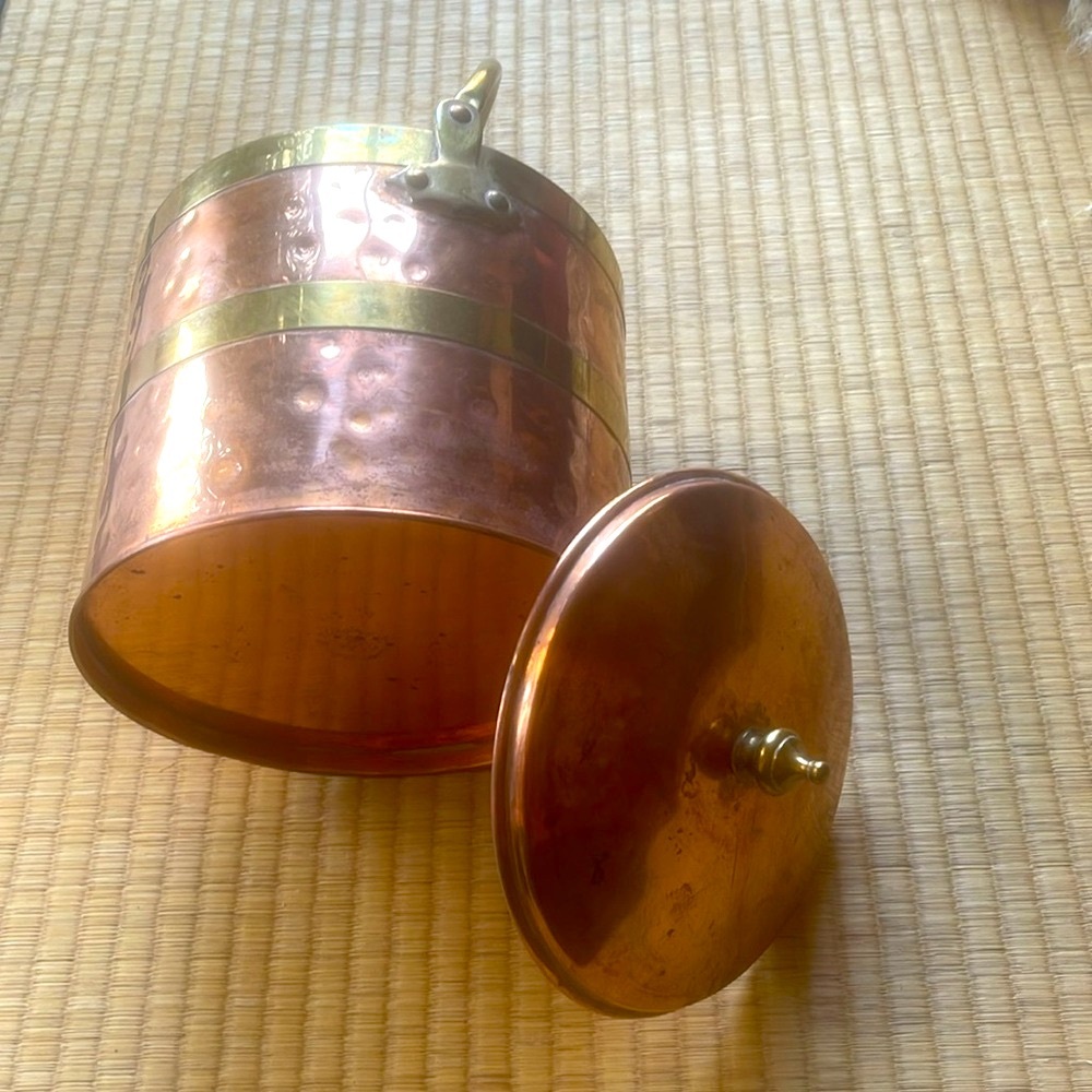 Vintage hammered copper ice/champagne bucket with brass trim lined with glass.